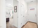 Bright entryway with white walls, a stylish rug, and a glimpse into a sunlit living space at 1126 Talisker Way, Burlington, NC 27215