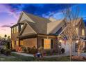 This home features a brick exterior, a two-car garage and a cozy outdoor seating area on a lush green lawn at 1126 Talisker Way, Burlington, NC 27215