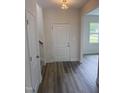 Bright entryway featuring wood-look flooring, a closet and natural light from a window with views of the yard at 122 Reece Dr, Sanford, NC 27332