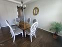 Bright dining room features hardwood floors, glass top dining table and seating for six; perfect for entertaining at 1520 Village Grove Ct, Hillsborough, NC 27278