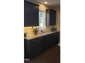 The kitchen boasts dark cabinets, granite countertops, stainless steel appliances, and a tiled backsplash at 1520 Village Grove Ct, Hillsborough, NC 27278