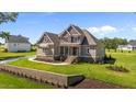 Beautiful home featuring a manicured lawn and inviting front porch with detailed trim and updated landscaping at 165 Cotton Fields Ln # 25, Fuquay Varina, NC 27526