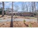 Elegant brick home with a mature trees, gravel driveway, and lovely landscaping at 221 Saddle Ridge Rd, Chapel Hill, NC 27514