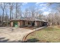 Sprawling single-story brick house featuring a green garage door and manicured lawn at 221 Saddle Ridge Rd, Chapel Hill, NC 27514