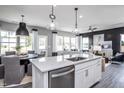 Open-concept kitchen with stainless steel appliances, granite countertops, and breakfast bar seating at 281 Broomside Ave, Raleigh, NC 27603