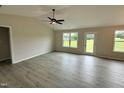 Spacious living room with ample natural light, modern wood floors, and ceiling fan at 39 N Movado Trl, Kenly, NC 27542