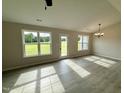 Bright living room featuring modern wood flooring, neutral paint, and large windows for natural light at 39 N Movado Trl, Kenly, NC 27542