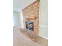 Close-up view of a classic brick fireplace with wooden mantel, providing warmth and charm to the living space at 4204 Labrador Dr, Raleigh, NC 27616