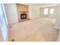Spacious living room featuring a brick fireplace, and a door for easy outdoor access at 4204 Labrador Dr, Raleigh, NC 27616