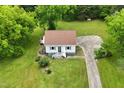 Aerial view of home with mature landscaping, and an expansive driveway at 524 N Occoneechee St, Hillsborough, NC 27278