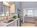Modern kitchen featuring stainless steel appliances, marble countertops, and bright natural light at 524 N Occoneechee St, Hillsborough, NC 27278