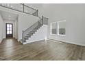 Spacious foyer with staircase and hardwood floors, creating an elegant entrance to the home at 63 Daybreak Way, Fuquay Varina, NC 27526