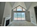 Bright living room with fireplace and large windows offering natural light at 63 Daybreak Way, Fuquay Varina, NC 27526