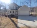 Charming two-story home with a covered porch and two-car garage, situated on a well-maintained lot at 632 Angus Ct, Sanford, NC 27332