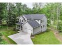 An aerial view of the home showcasing its architectural design, two-car garage, and surrounding greenery at 632 Angus Ct, Sanford, NC 27332