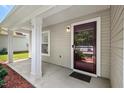Close-up of the front door entrance with sidelight and columned porch at 634 Conover Rd, Durham, NC 27703
