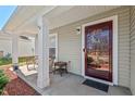 Inviting covered front porch with outdoor seating area and stylish front door entrance at 634 Conover Rd, Durham, NC 27703