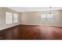 Spacious living area with hardwood flooring and modern lighting fixture at 634 Conover Rd, Durham, NC 27703