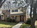 Traditional townhouse featuring brick facade, neutral siding, dark shutters, and well-maintained landscaping at 6525 New Market Way, Raleigh, NC 27615