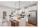 Bright kitchen features stainless steel appliances, white cabinetry, and a spacious center island at 917 Montague Ave, Durham, NC 27703