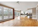 Open-concept living room with hardwood floors connects to a modern kitchen at 100 Burlingame Way, Cary, NC 27513