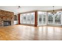Spacious living room features hardwood floors, stone fireplace, and ample natural light at 100 Burlingame Way, Cary, NC 27513