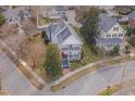An aerial shot of a home featuring a charming white facade, solar panels, and proximity to a tree-lined street at 101 Overlake Dr, Chapel Hill, NC 27516