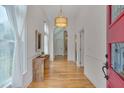 Bright foyer with light wood floors, complemented by a stylish table and elegant lighting at 101 Overlake Dr, Chapel Hill, NC 27516