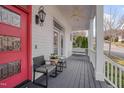 Inviting front porch with stylish seating, ceiling fan, and a swing for relaxation at 101 Overlake Dr, Chapel Hill, NC 27516