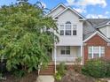 Attractive two-story home with a covered front porch and mature trees at 1012 Palace Garden Way, Raleigh, NC 27603