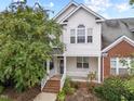 Inviting two-story home featuring a covered front porch and well-maintained landscaping at 1012 Palace Garden Way, Raleigh, NC 27603