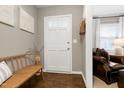 Cozy entryway with wood floors, a bench, and access to the living area at 1405 Suterland Rd, Cary, NC 27511