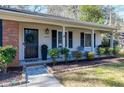 Inviting front porch featuring decorative wreath and a cozy seating area at 1405 Suterland Rd, Cary, NC 27511