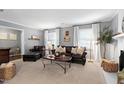 Comfortable living room with a fireplace, plush seating, and ample natural light at 1405 Suterland Rd, Cary, NC 27511