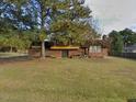 Charming brick home with a spacious front yard and mature trees providing ample shade at 1617 Chase St, Rocky Mount, NC 27801