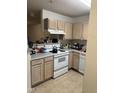 Functional kitchen with white appliances, light wood cabinets, and essential cooking equipment for everyday meals at 2002 Technology Woods Drive # 103, Raleigh, NC 27603