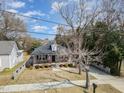 Charming home with inviting front porch, swing, and well-maintained yard and sidewalk at 202 W Hill St, Benson, NC 27504