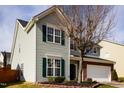 Well-maintained two-story home with green shutters and a manicured lawn at 2344 Lazy River Dr, Raleigh, NC 27610