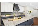 Modern kitchen with white cabinets, granite countertops, stainless steel appliances, and island at 2515 Maplemere Ct, Durham, NC 27703