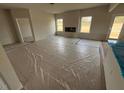 Spacious living room featuring an electric fireplace and two bright windows at 30 Olivia Crossing Ct, Smithfield, NC 27577