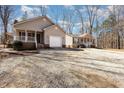 Charming homes with a large gravel driveway and well-maintained lawns offer a welcoming curb appeal at 3011 Little Creek Ln, Hillsborough, NC 27278