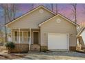 Charming house with a covered porch, garage, and a well-maintained yard shows great attention to detail at 3011 Little Creek Ln, Hillsborough, NC 27278