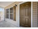Inviting front porch features a classic door and charming details, creating a warm welcome at 3011 Little Creek Ln, Hillsborough, NC 27278