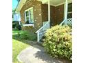 Inviting front porch with white lattice and steps leading to a cozy entrance, perfect for enjoying the outdoors at 323 Ranch Farm Rd, Raleigh, NC 27603