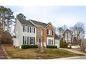 Lovely two-story home boasts a blend of classic architecture and verdant surroundings at 3528 Dewing Dr, Raleigh, NC 27616