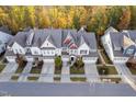 Beautiful aerial view of townhomes showcasing manicured landscaping, driveways, and autumn foliage at 357 Roberts Ridge Dr, Cary, NC 27513