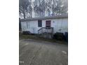 Back view of a single story home with a small deck and door at 4805 Barbee Rd, Durham, NC 27713