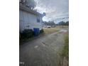 A narrow driveway sits next to the home with a gray garbage can at 4805 Barbee Rd, Durham, NC 27713