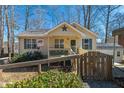 Close up of a charming one-story home featuring a cozy porch with a decorated entryway and a gravel driveway at 4901 North Pointe, Sanford, NC 27332