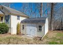 Backyard view of a shed with double doors, matching siding to the house and a well kept lawn at 4901 North Pointe, Sanford, NC 27332